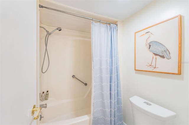 bathroom featuring shower / tub combo with curtain and toilet