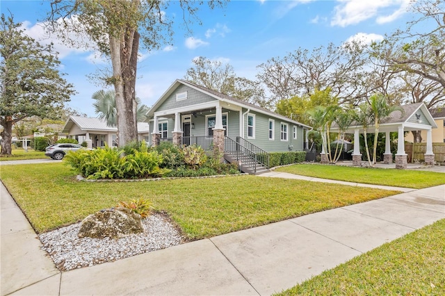 craftsman house with a front yard and covered porch