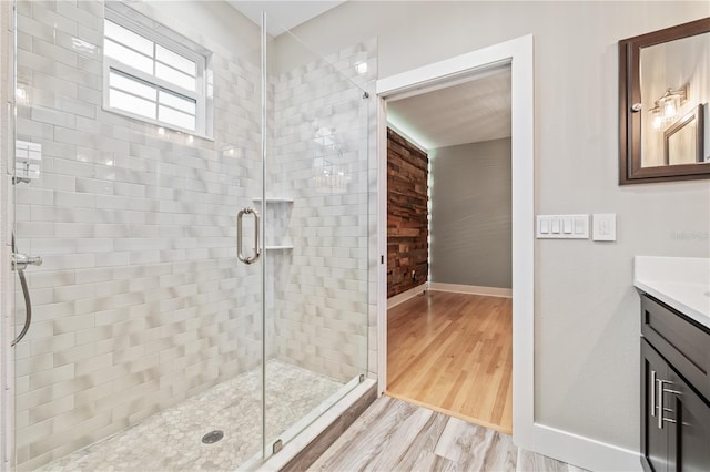 bathroom featuring vanity, hardwood / wood-style floors, and an enclosed shower