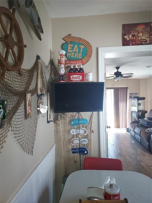 dining area with ceiling fan and wood-type flooring