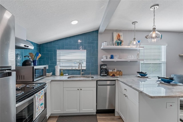 kitchen featuring pendant lighting, sink, stainless steel appliances, light stone counters, and white cabinets