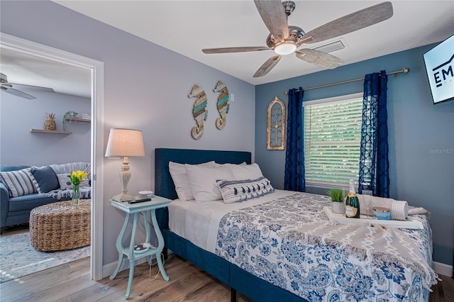 bedroom featuring hardwood / wood-style flooring and ceiling fan