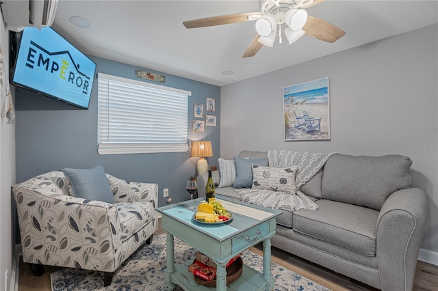 living room with wood-type flooring and ceiling fan