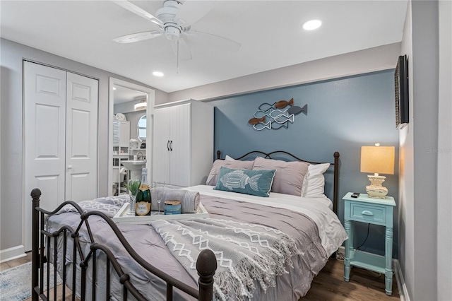 bedroom with a closet, dark hardwood / wood-style floors, and ceiling fan