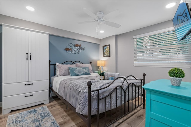 bedroom with ceiling fan and light hardwood / wood-style flooring