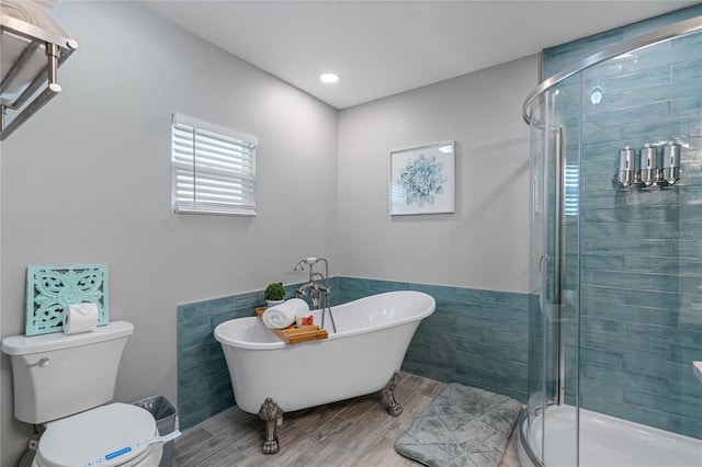 bathroom featuring wood-type flooring, independent shower and bath, and toilet