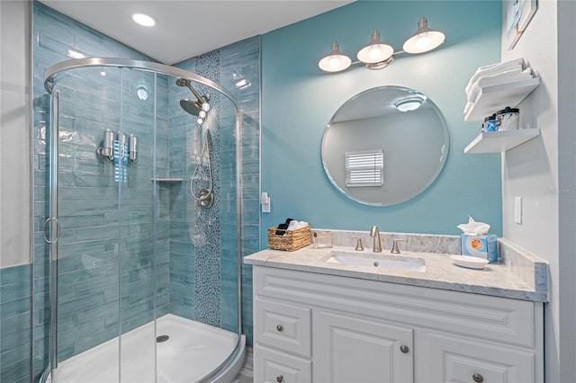 bathroom featuring vanity and an enclosed shower