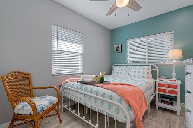 bedroom with ceiling fan and light wood-type flooring