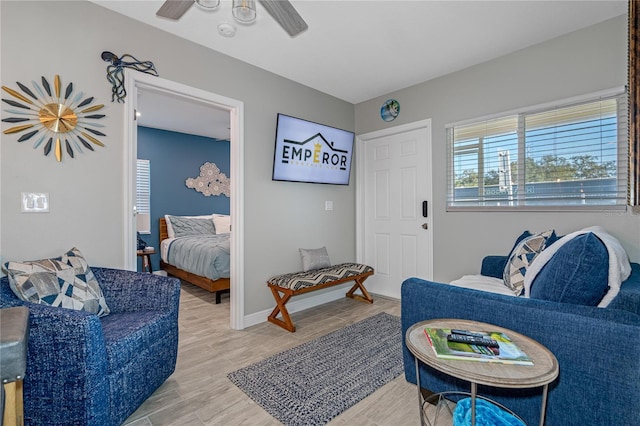 sitting room with hardwood / wood-style flooring and ceiling fan