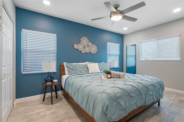 bedroom with hardwood / wood-style flooring, ceiling fan, and a closet