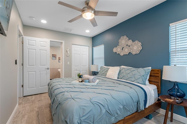 bedroom with ceiling fan, light wood-type flooring, and a closet