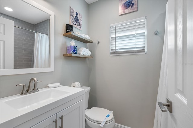 bathroom featuring vanity, toilet, and a shower with shower curtain