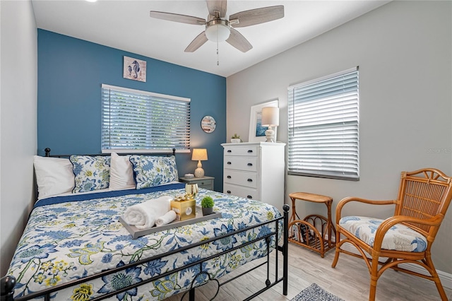 bedroom with ceiling fan and light wood-type flooring