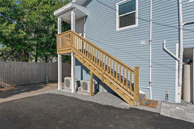 view of exterior entry with ac unit and a patio area