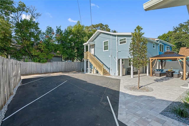 exterior space with a gazebo, an outdoor hangout area, and a patio