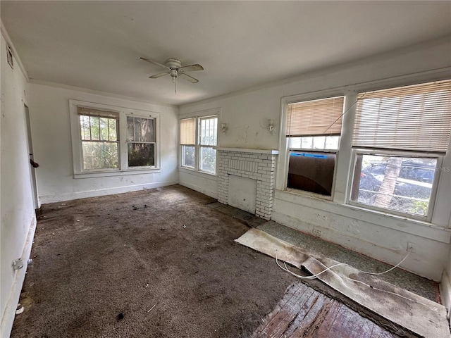 unfurnished living room with ceiling fan, carpet floors, and a brick fireplace