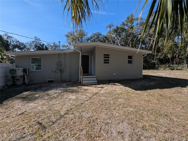 view of front facade with a front lawn and ac unit