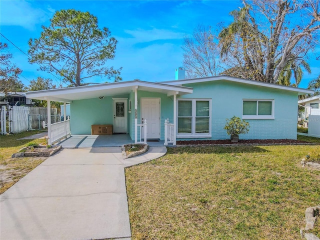 ranch-style home featuring a carport and a front lawn