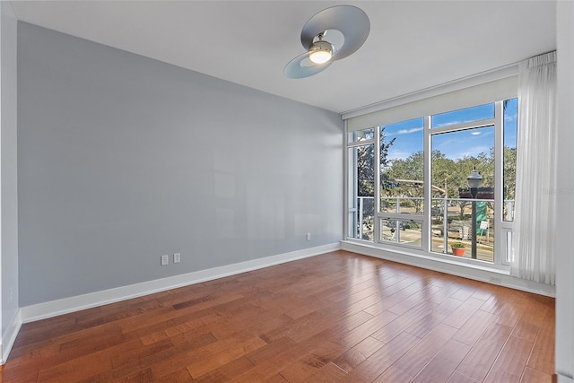 empty room with ceiling fan and wood-type flooring