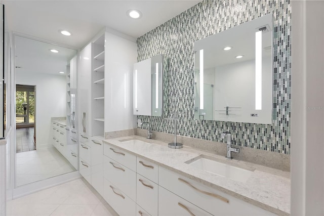 bathroom with tasteful backsplash, vanity, and tile patterned floors