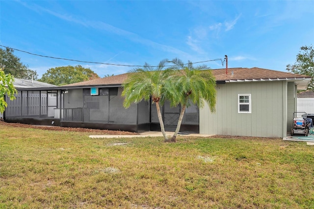 back of house featuring a sunroom and a yard