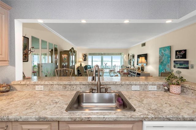 kitchen with ornamental molding, sink, light brown cabinets, and white dishwasher