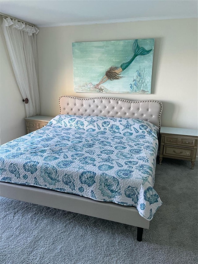 bedroom featuring ornamental molding and carpet flooring