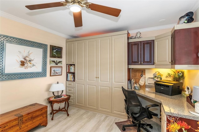 office area with built in desk, ornamental molding, and light wood-type flooring