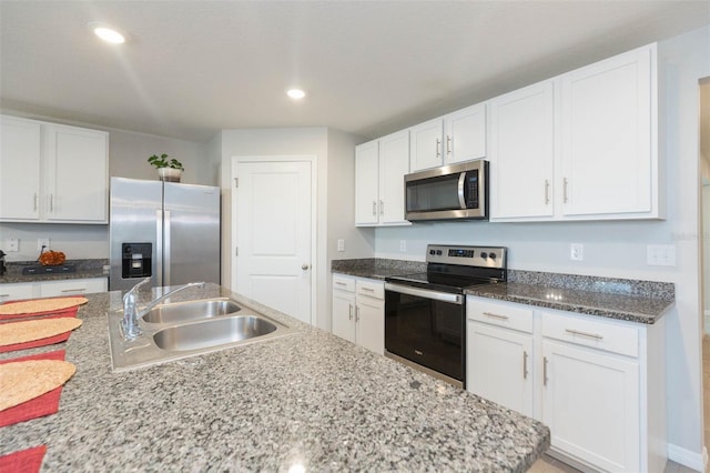 kitchen featuring stainless steel appliances, sink, and white cabinets