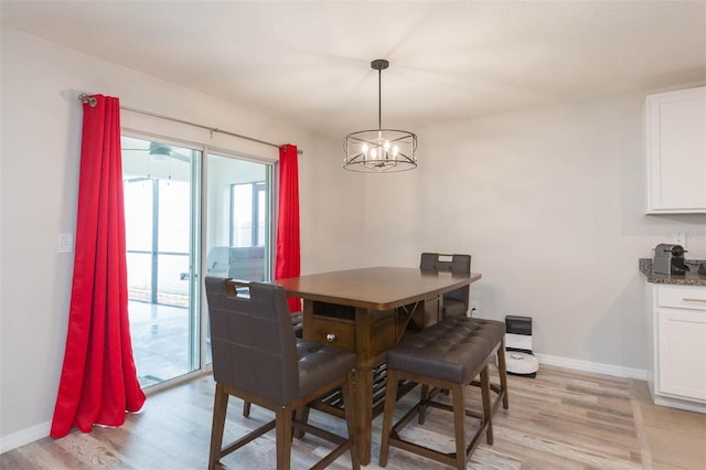 dining space with an inviting chandelier and light wood-type flooring