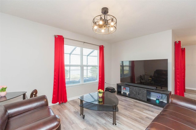 living room featuring light hardwood / wood-style floors and a chandelier