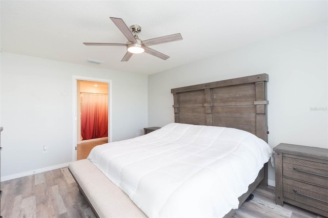 bedroom featuring ceiling fan, connected bathroom, and light hardwood / wood-style floors