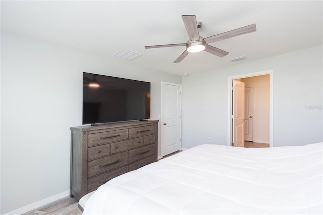 bedroom with ceiling fan and light hardwood / wood-style floors