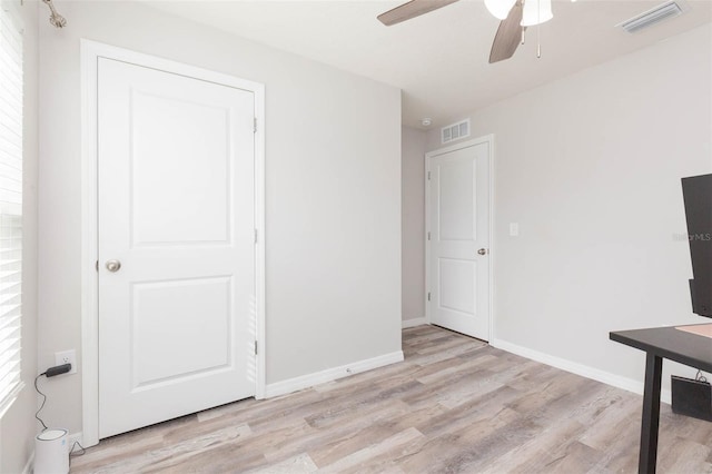 unfurnished office featuring ceiling fan and light wood-type flooring