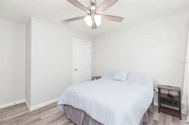 bedroom with ceiling fan and light hardwood / wood-style floors