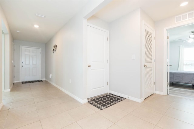 entryway with light tile patterned flooring and ceiling fan