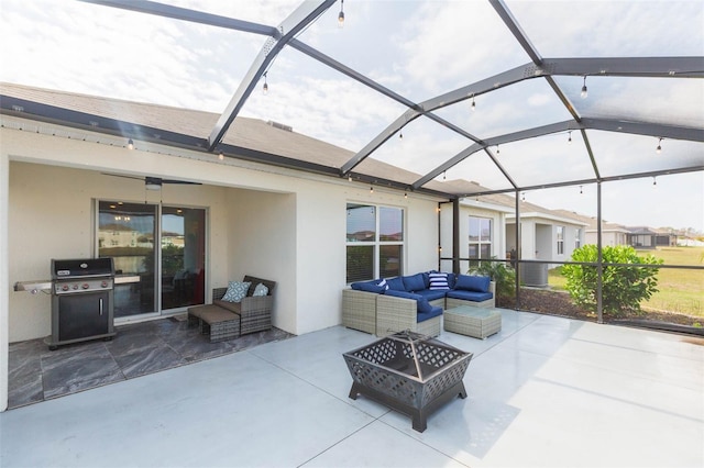 view of patio / terrace with a grill, an outdoor living space with a fire pit, and glass enclosure