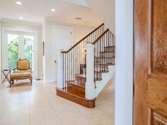 stairs featuring ornamental molding and tile patterned floors