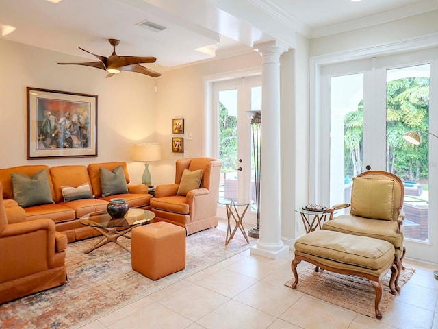 living room with french doors, crown molding, decorative columns, and light tile patterned floors