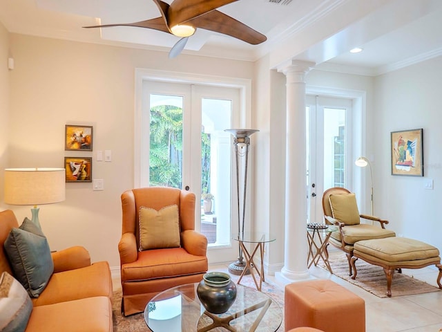 living room featuring decorative columns, ornamental molding, light tile patterned floors, ceiling fan, and french doors