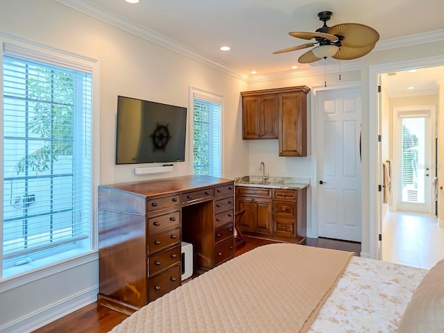 kitchen with crown molding, sink, a wealth of natural light, and dark hardwood / wood-style flooring