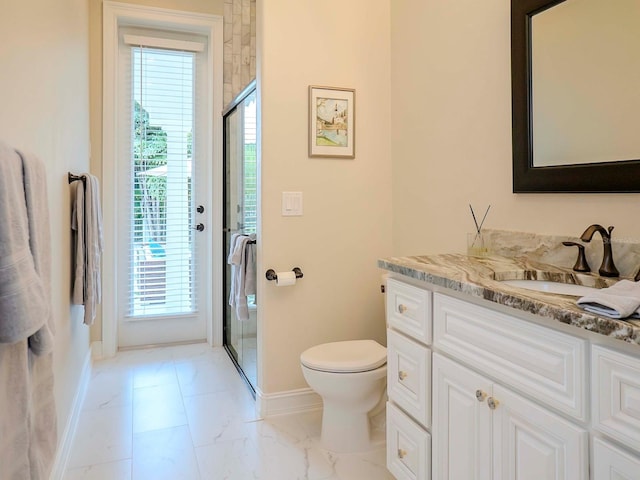 bathroom featuring walk in shower, vanity, and toilet