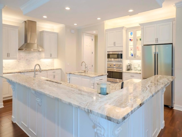 kitchen with white cabinetry, wall chimney exhaust hood, and a large island