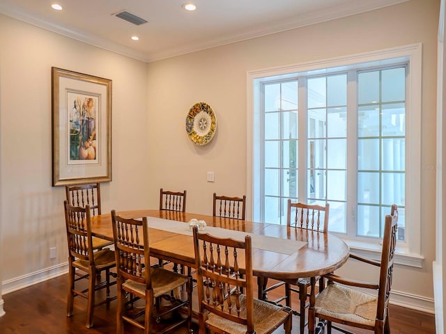 dining area featuring crown molding and dark hardwood / wood-style flooring