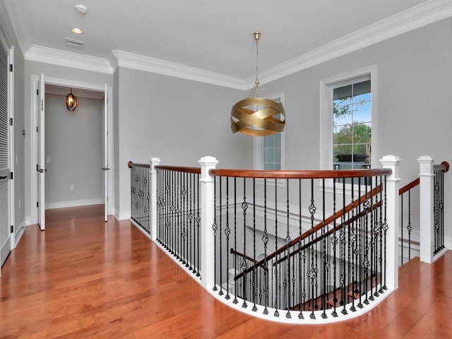 hallway featuring ornamental molding and hardwood / wood-style floors