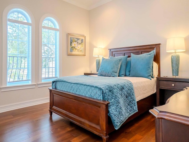 bedroom with dark hardwood / wood-style floors