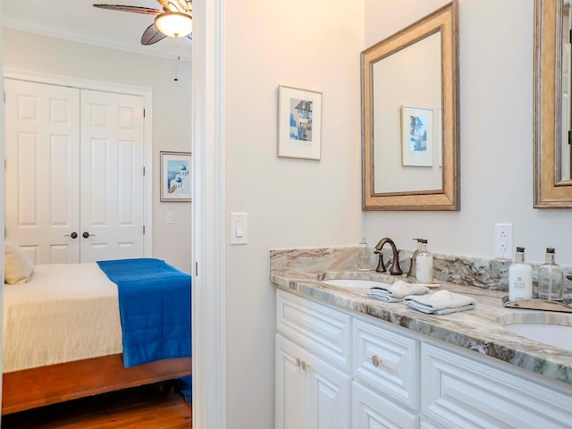 bathroom featuring crown molding, ceiling fan, vanity, and hardwood / wood-style floors