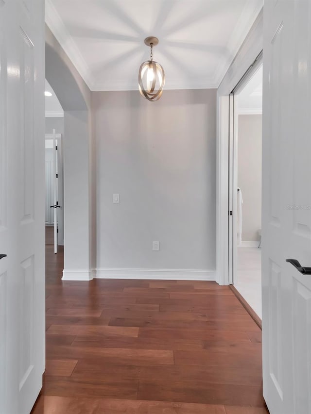 interior space featuring crown molding and dark hardwood / wood-style flooring