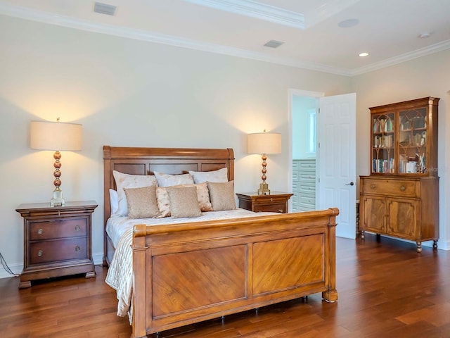 bedroom with ornamental molding and dark wood-type flooring