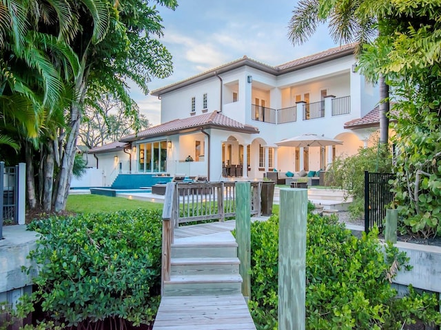 rear view of property featuring outdoor lounge area